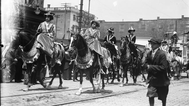Circus employees in exotic costumes ride horses in the 1910 parade. The phrase "hold your horses" originated as a warning to local horsemen when circus elephants paraded through town.