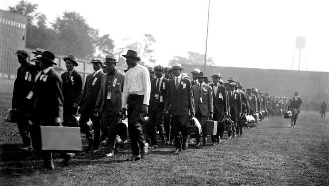 Black recruits arrive at Camp Custer for training during World War I. The black soldiers were segregated for training, service and social activities.
