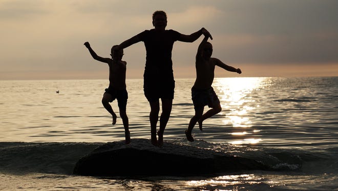 They live in Chatham, Illinois, but Deb Barber and her family have been vacationing in southwest Michigan for five generations. Sunset at the public beach in Douglas, on Lake Michigan, was irresistible to grandsons Eli and Ian Bostrom, as well as Deb's wife Diane VanderKooy, who joined them in a jump for joy. "We LOVE our trips to Michigan!" Barber says.