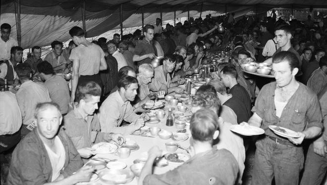 The circus staff fills a tent at mealtime.