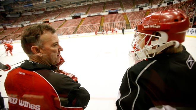 Goaltending coach Jim Bedard and goalie Chris Osgood chat during practice before Game 2 of the Stanley Cup Finals at Joe Louis Arena, May 26, 2008.