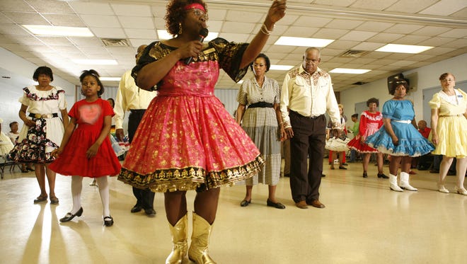 A lady calls the moves at the Dudes and Dolls dance at the Adams Butzel Recreation Center NNHEC in Detroit on Tuesday, May 9, 2006.