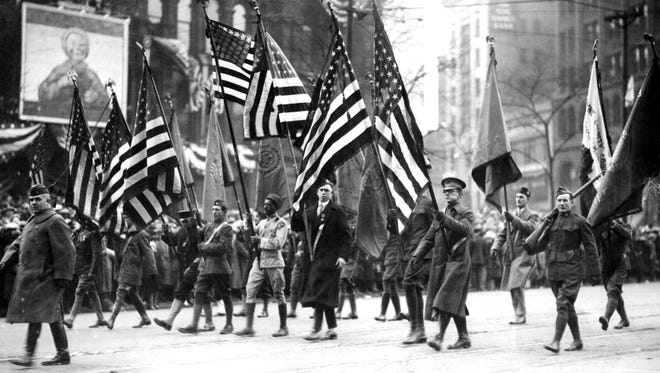 Soldiers march in a conscription parade in Detroit during World War I to encourage more recruits to join the war effort.