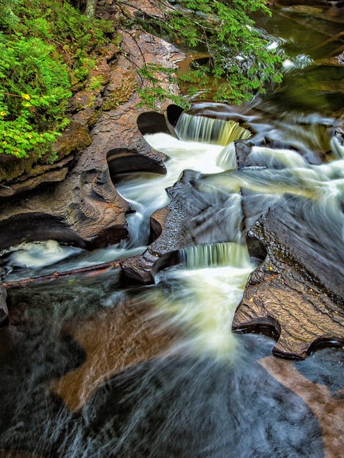 WOODS AND WILDLIFE FINALISTS: For Beverly Wolf of Waterford, the highlight of an Upper Peninsula fall camping tour was crossing the suspension bridge over the Presque Isle River in Porcupine Mountains Wilderness State Park. "The kettles, or potholes as they are sometimes called, were easily visible and so striking that they almost took my breath away," she said. A long exposure helped to convey the movement of the water.
