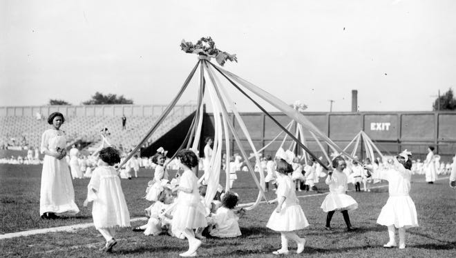 Children dance around a May Pole in this undated photo.