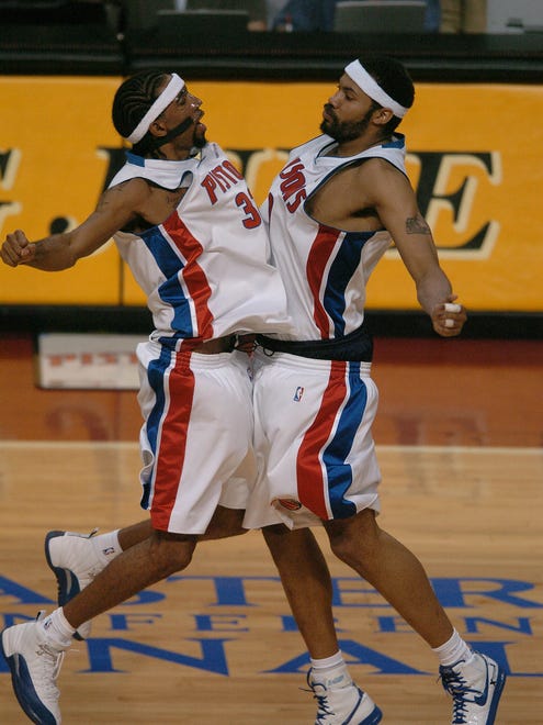 Richard Hamilton and Rasheed Wallace celebrate near end of the  Eastern Conference Finals game between the Pistons and Indiana Pacers on May 26, 2004.