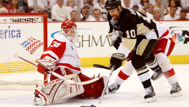 Detroit's Chris Osgood makes a save on a shot by Pittsburgh's Gary Roberts during Game 6 of the Stanley Cup Finals at Mellon Arena, June 4, 2008.