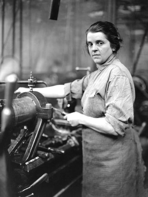 A munitions worker pauses while she works at the Lincoln Motor Co. during World War I.
