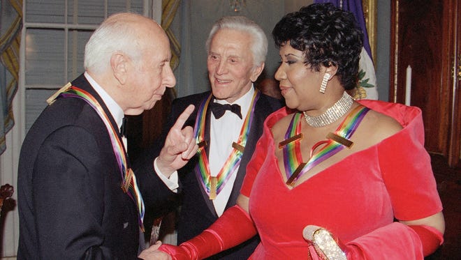 Composer Morton Gould, left, and actor Kirk Douglas talk with Aretha Franklin following a dinner at the State Department in Washington, Dec. 3, 1994. The dinner was held to honor them as recipients of the Kennedy Center Honors of 1994. Also honored were songwriter Pete Seeger and director Harold Prince. (AP Photo/Doug Mills)