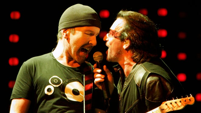U2's The Edge (left) and Bono share the mic during a sold-out show at The Palace on October 24, 2005.