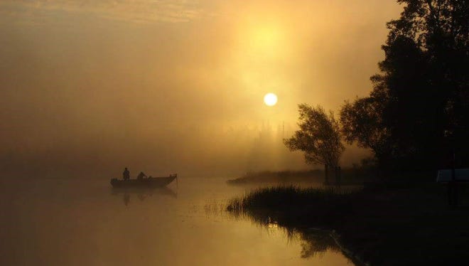 FOUR-SEASON FUN WINNER: "Misty Fishing Morning," by Diane Kanneth of Highland Park. One morning in Commerce Township, she got up early and headed down to Proud Lake, trying not to drop her coffee, granola bar and camera.  "In that struggle," she said, "I lifted my camera in the direction of the boaters that captured my attention. The photo I quickly snapped without much expertise or thought reminds me of that one beautiful morning."