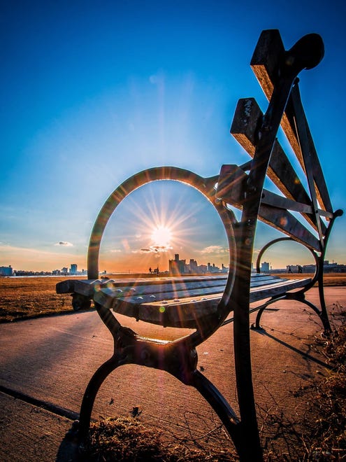CITY AND COUNTRY PEOPLE'S CHOICE WINNER:  In "Solar Power," Izzy Cagalawan of Macomb used a bench on Belle Isle to frame the sun setting over the RenCen.  "It's just a product of my constant search for something different," Cagalawan said.
