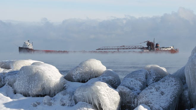 "Winter Arrival in Marquette," by Rod Burdick of Negaunee. When the Laker Kaye E. Barker arrived at Presque Isle Harbor, Marquette, on a frigid December morning, "The sea smoke on Lake Superior and iced-over rocks on the lakeshore caught
my eye," he said.