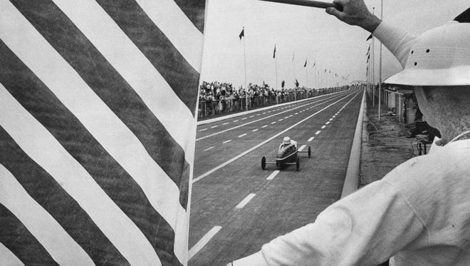 Marvin Smotherman waves a flag at the 1962 Soap Box Derby.