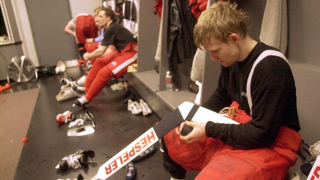 Chris Osgood tapes up his stick after practice at the Staples Center in Los Angeles, April 18, 2001.