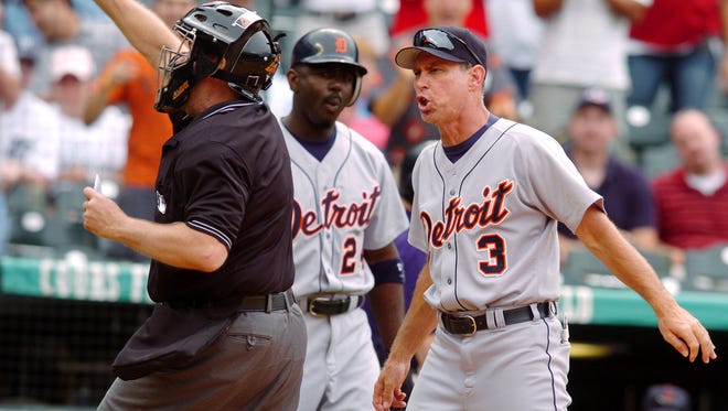 Home plate umpire Gary Cederstrom, left, ejects Detroit Tigers  manager Alan Trammel, right, as Tigers batter Rondell White looks on in the ninth inning of the Tigers' 10-8 loss to the Colorado Rockies in an interleague contest in Denver on Sunday, July 4, 2004. Trammel was arguing a called strike three on Tigers batter Carlos Guillen, who was also tossed from the contest.