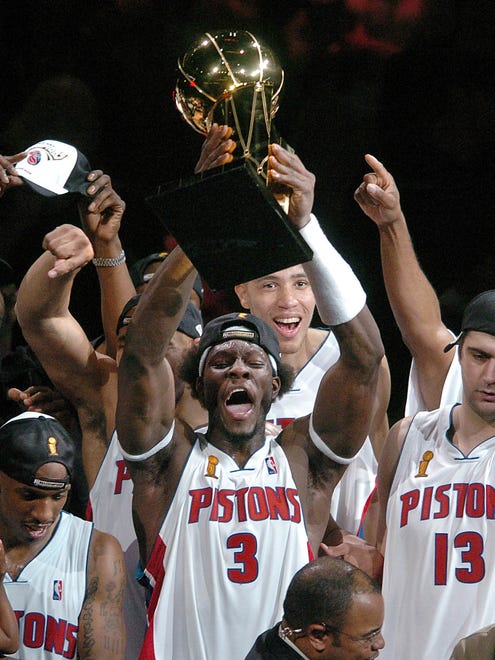 Ben Wallace holds the world championship trophy aloft as the Pistons beat the Lakers in Game 5 at The Palace of Auburn Hills in 2004.
