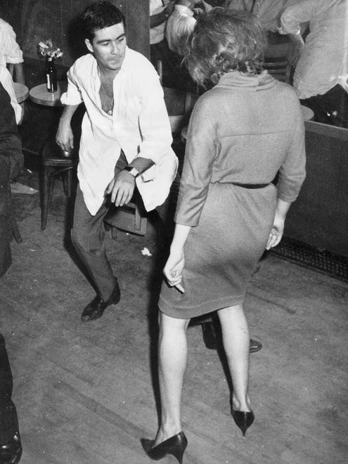 "Let's twist again, like we did last summer..." A  couple does the newest dance craze of 1961.
