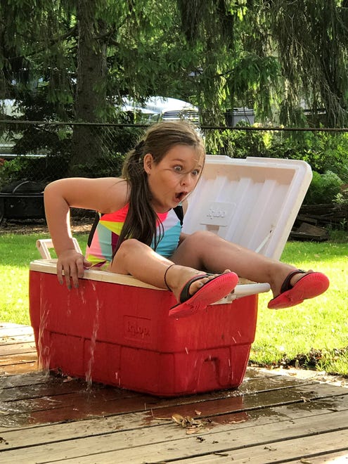 "Cooling Off,"by Jessica Caloni of Mount Clemens. The Calonis were sitting on their deck on a hot day. Next thing they know, 8-year-old Abbygail is filling up the cooler with water.  "We actually thought it was going to be for the dog, but nope, she decided to get in it herself," Jessica says. "It was quite entertaining."
