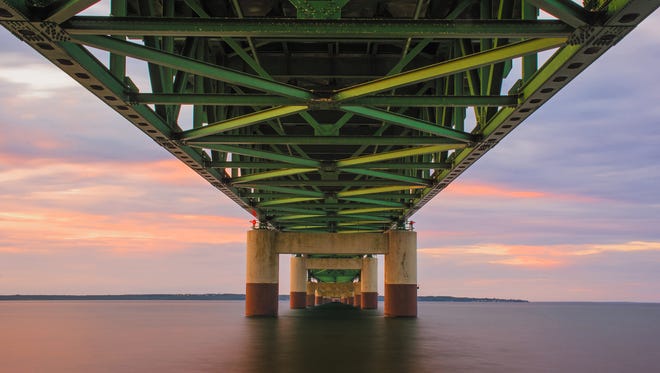 “Sunset in Troll Town,” by Cathy Bragiel of Pinconning, offers an unorthodox view of the Mackinac Bridge, shot from underneath it. She used a long exposure to smooth the water and capture all the colors of the sunset.