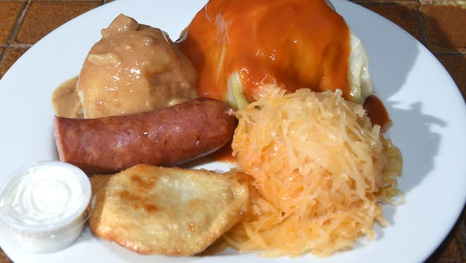 The Polish Plate know as "a taste of Poland" with a stuffed cabbage, potato and cheese pierogi, kielbasa, kraut and mash served at the Polish Village Cafe.