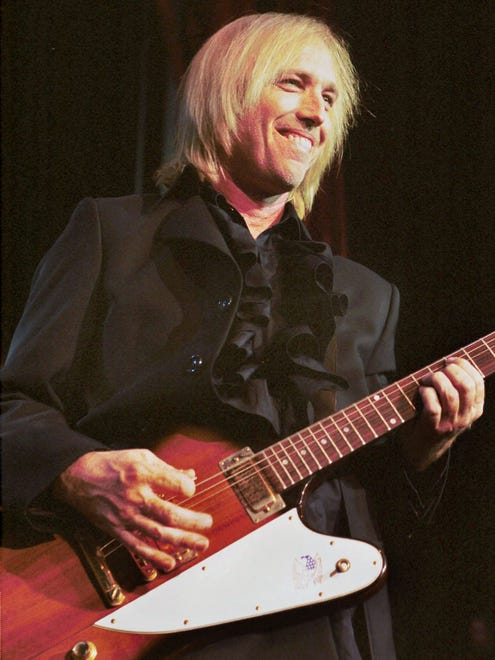 Tom Petty puts his band the Heartbreakers through their paces during their concert June 18, 1999 at the then-Pine Knob Music Theatre in Clarkston.
