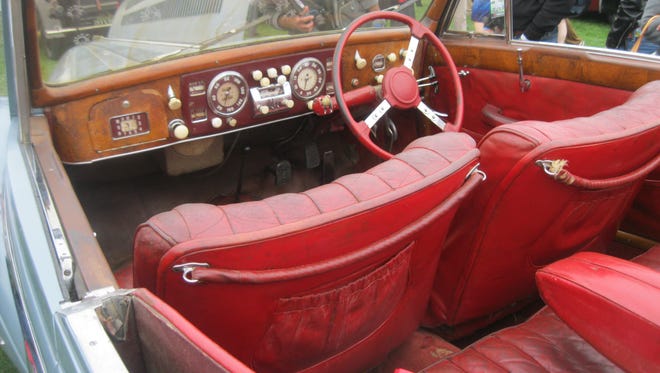 The red leather seats in the unrestored 1949 Delahaye Chapron convertible maintain their sense of luxury; the multiple knobs on the dashboard appear to include several replacements. A spokesman said the gray-blue exterior was mostly primer.