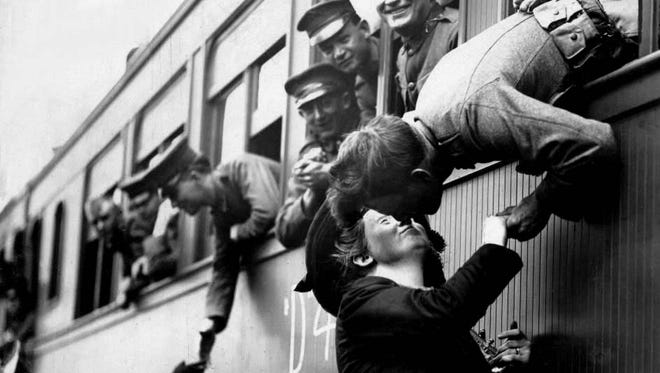 A solider tries to steal a kiss before his troop train pulls out of Michigan Central Depot in Detroit during World War I. "The war to end all wars" started in July 1914 with the assassination of Austria's Archduke Ferdinand and ended Nov. 11, 1918. We look here at the war and Michigan's part in it.