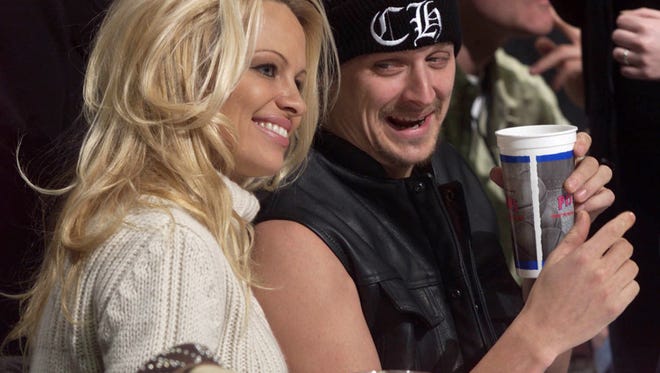 Kid Rock and Pam Anderson have some fun at a Detroit Pistons and Miami Heat game at The Palace in 2001.