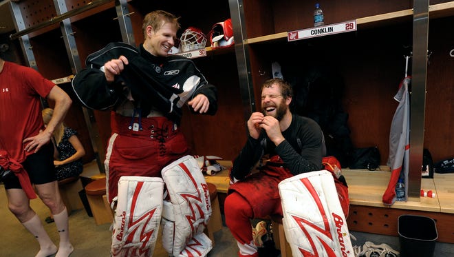 Detroit goaltenders Chris Osgood, left, and Ty Conklin share a laugh in front of their lockers after practice at Joe Louis Arena, in Detroit, June 8, 2009.