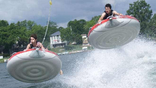 "It's All About Height," by Kim Corey of Highland, shows her nephew Nolan and his friend Johnny clinging to inner tubes as they bounce high off Runyan Lake in Fenton.  "Every summer I sit with my Sony a100 35mm zoom lens on the back of the boat trying to get some fun pictures of the kids," she says. "By the end of summer, I usually have enough pictures to put into a collage to show of all the fun that we have had."
