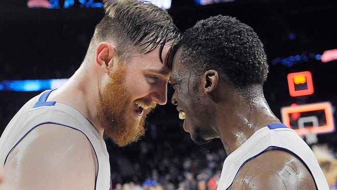 Detroit Pistons Aron Baynes and Reggie Jackson celebrate a victory over the Washington Wizards, 112-99,  at The Palace of Auburn Hills on April 8, 2016.  The Pistons made their first appearance in the playoffs in eight seasons, but were swept 4-0 in the first round by the eventual NBA champions, the Cleveland Cavaliers.