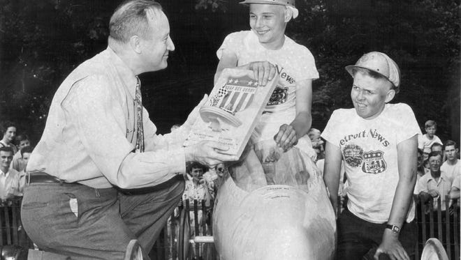 W.E. Fish of Chevrolet presents John P. Studnicky Jr. with the trophy in 1947. Runner-up was Walter W. Hammond, right.