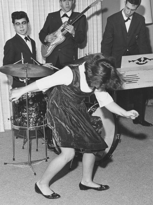 A young girl lets her hair down to some rock'n'roll in 1962.