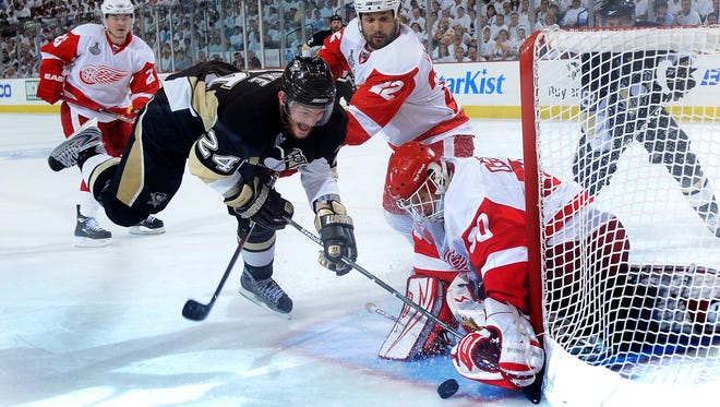 Pittsburgh's Matt Cooke has a shot stopped by Detroit Red Wings goalie Chris Osgood during the Stanley Cup Finals at Mellon Arena in Pittsburgh, Pennsylvania on June 2,  2009.