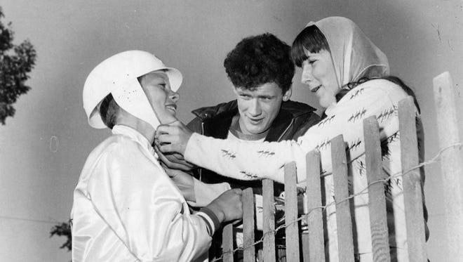 Kathy Bielicki adjusts the helmet of her son, derby contestant Richard Bielicki, 13, in 1967.