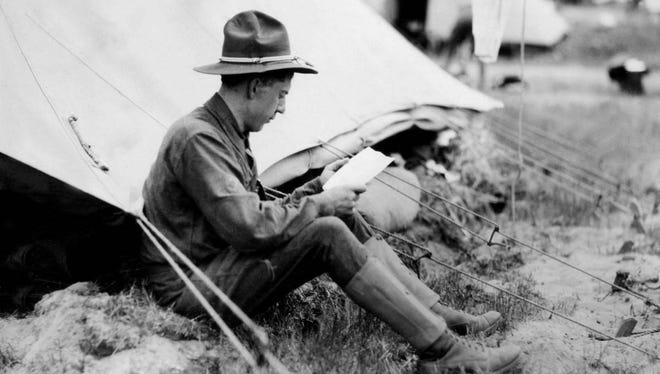 A soldier writes a letter at U.S. Army Camp Custer near Battle Creek.
