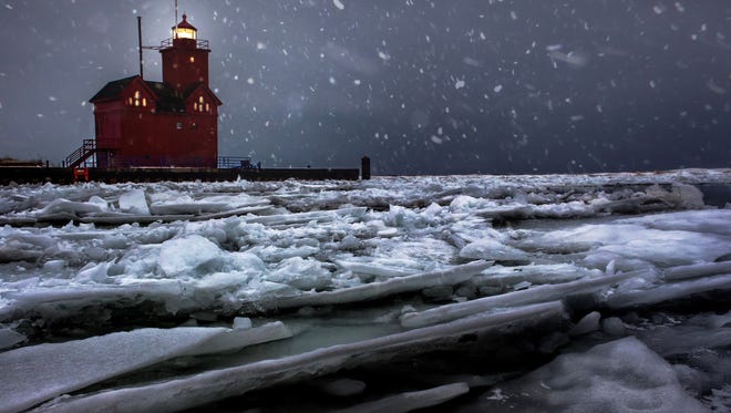 CITY AND COUNTRY WINNER: A blizzard was hitting Lake Michigan in Holland when Chase Gagnon of Madison Heights lay down on the breakwall and put his camera near the icy water to create "Big Red Blizzard." He said, "I had no idea if my composition was good or bad until I brought the camera back up to check. I think I had to do this six or seven times until I had a shot I liked.  After that I went back to my car and turned the heat up as high as it would go."