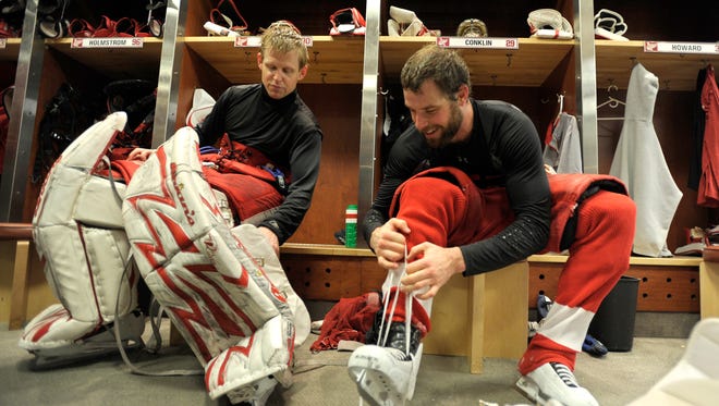 Goalies Chris Osgood, left, and Ty Conklin get undressed after practice at Joe Louis Arena, in Detroit, May 26, 2009.
