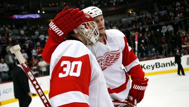 Chris Osgood and Darren McCarty celebrate after a win against the Colorado Avalanche during the Western Conference semi-finals at the Pepsi Center, May 1, 2008.