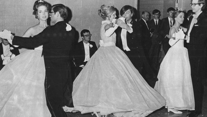 Couples twirl at a formal dance in 1971.