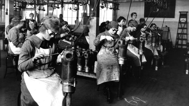 A room full of female munitions workers weld machine parts at the Lincoln Motor Co. during World War I.
