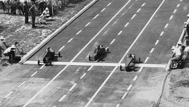 Racers Edward Margovich, Douglas Dickenson and Jim Monkiewicz make a tight finish in a 1963 heat.