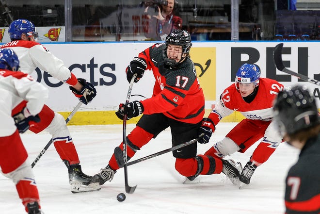 Boston University's Macklin Celebrini, center, led Canada in scoring with eight points in five games at the world U20 championship in Gothenburg, Sweden.