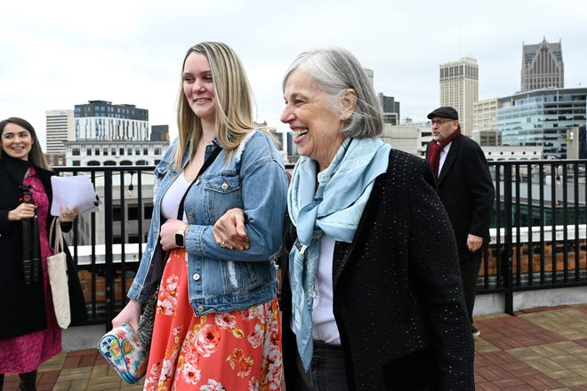 Lauren Wagner, right, is escorted by Alexandra Dennis, memory care director at StoryPoint Saline, as they get a tour along the roof of the Detroit Opera House, Saturday, March 9, 2024, in Detroit.