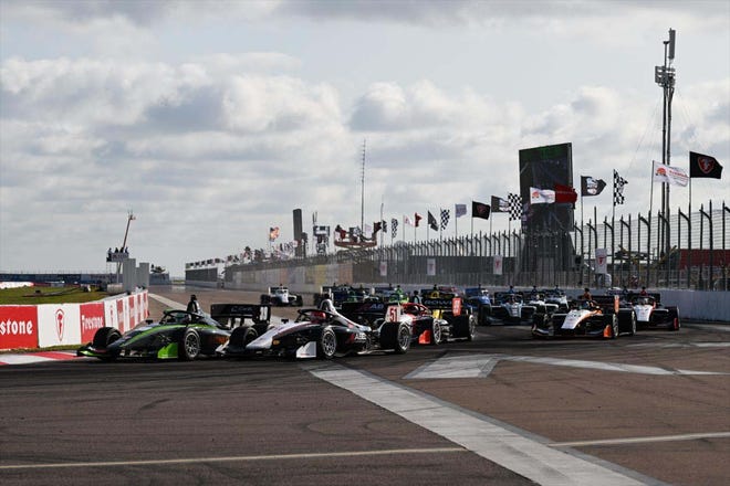 The Indy NXT field - including Nolan Allear mid-pack - swarms Turn One at the start of the St. Pete race.