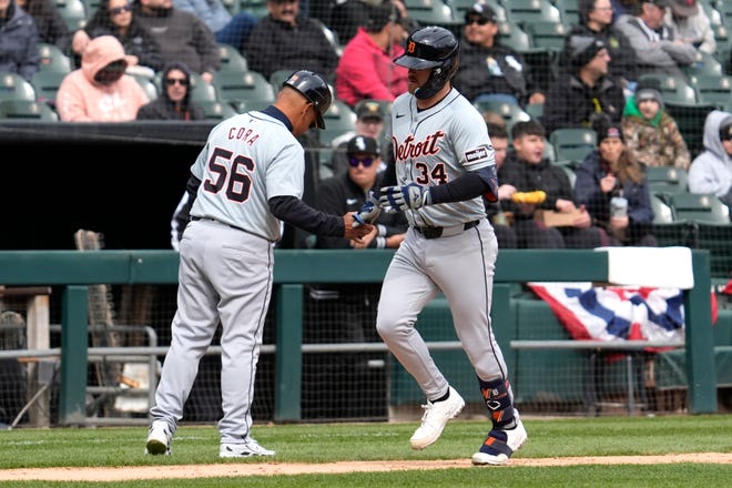 Detroit Tigers' Jake Rogers, right, celebrates with third base coach Joey Cora as he rounds the bases after hitting a solo home run during the fifth inning.