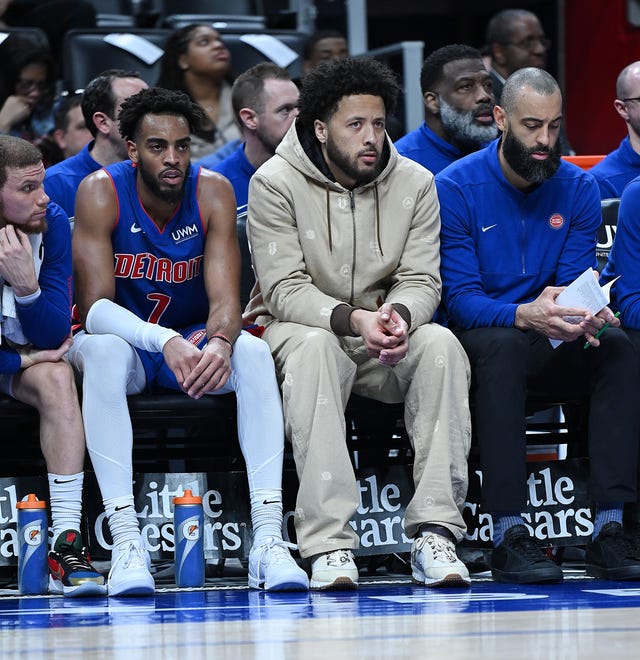 Detroit Pistons guard Cade Cunningham (2, center), sits on the bench in street clothes in the second quarter. Detroit Pistons vs Chicago Bulls, Little Caesars Arena, April 11, 2024, in Detroit, MI.