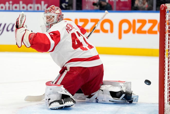 Red Wings goaltender James Reimer allows a goal by Maple Leafs' Nicholas Robertson during the second period.