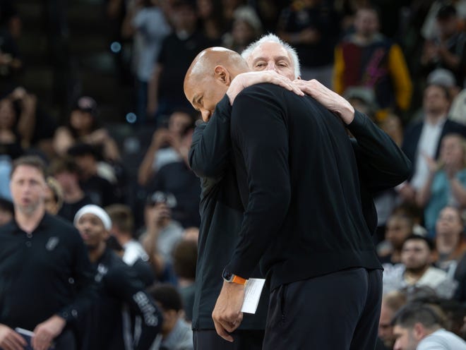 San Antonio Spurs head coach Gregg Popovich, right, hugs Detroit Pistons head coach Monty Williams, left, after an NBA basketball game, Sunday, April 14, 2024, in San Antonio. (AP Photo/Michael Thomas)